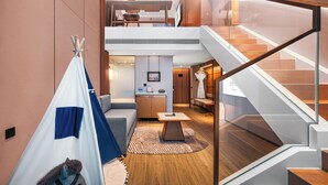 A modern hotel interior with a loft bedroom, a dining area, and a staircase. - Wanda Moments Changchun (Changchun)