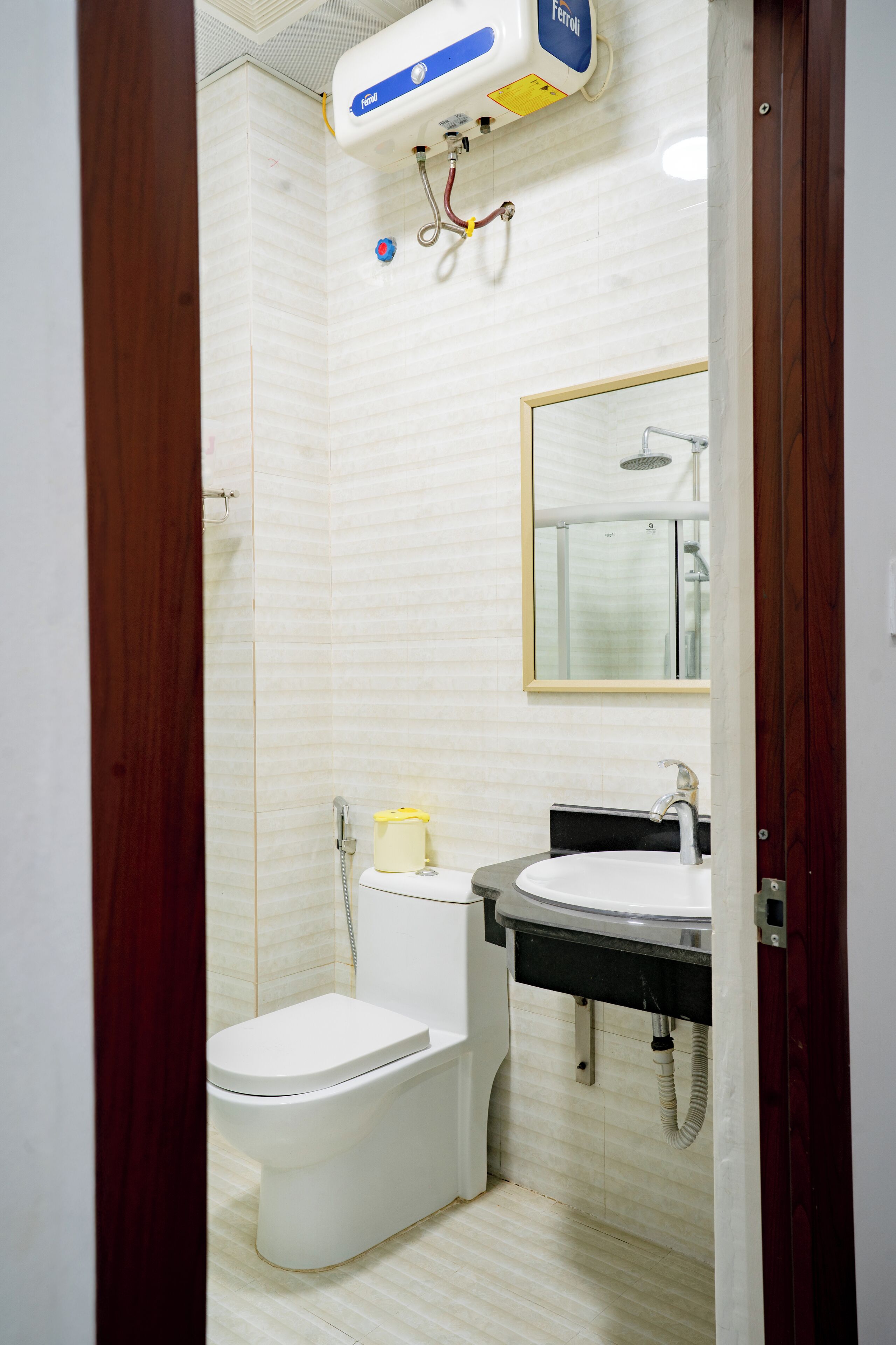 A bathroom with a toilet, sink, and shower.