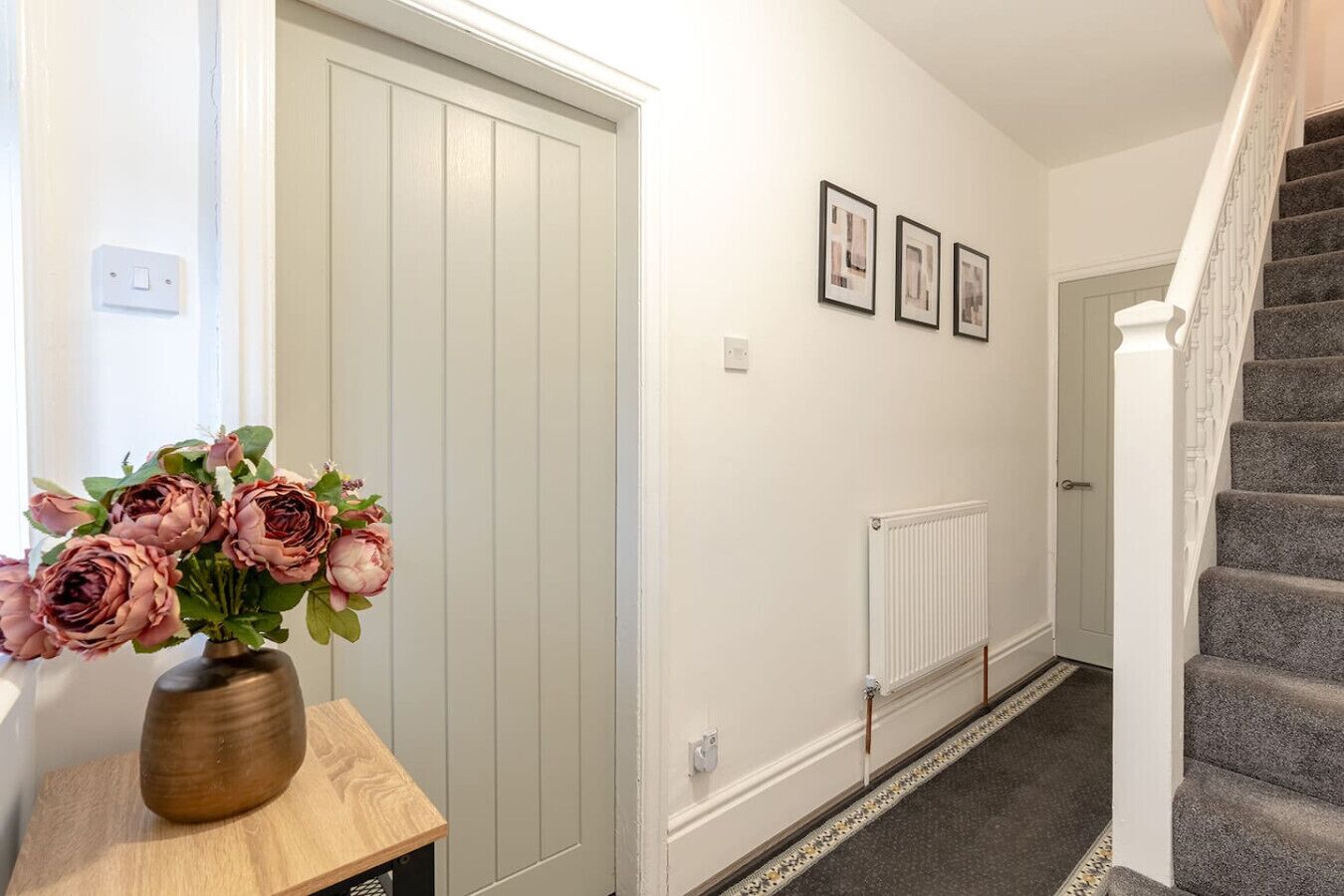 Step inside to a bright entrance area with stairs and simple decor