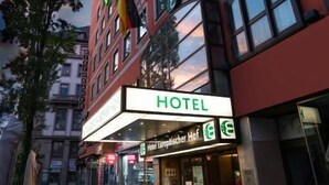 A hotel with a prominent "HOTEL" sign, a visible entrance, and a flag. - Hotel Europäischer Hof  (Munich)