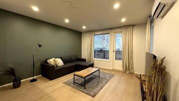 Standard Apartment, City View | Living area | Flat-screen TV