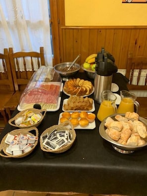 A breakfast buffet with various food items and beverages.