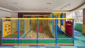 A play area with a ball pit, netted play structures, and a slide. - MUMU JIAO-XI (Jiaoxi)