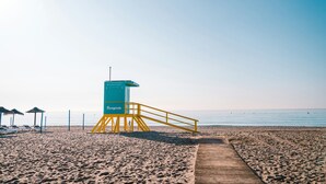 A lifeguard tower on a beach with a wooden walkway leading to it. - Fuengirola Center Rooftop Terrace (Fuengirola)