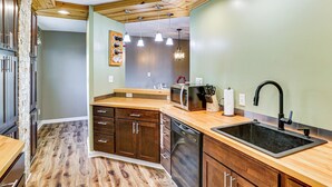A kitchen with wooden cabinets, a dishwasher, a microwave, and a sink. - 6 Mi to Dtwn Cincinnati: Dog-friendly Apt w/ Yard (Cincinnati)