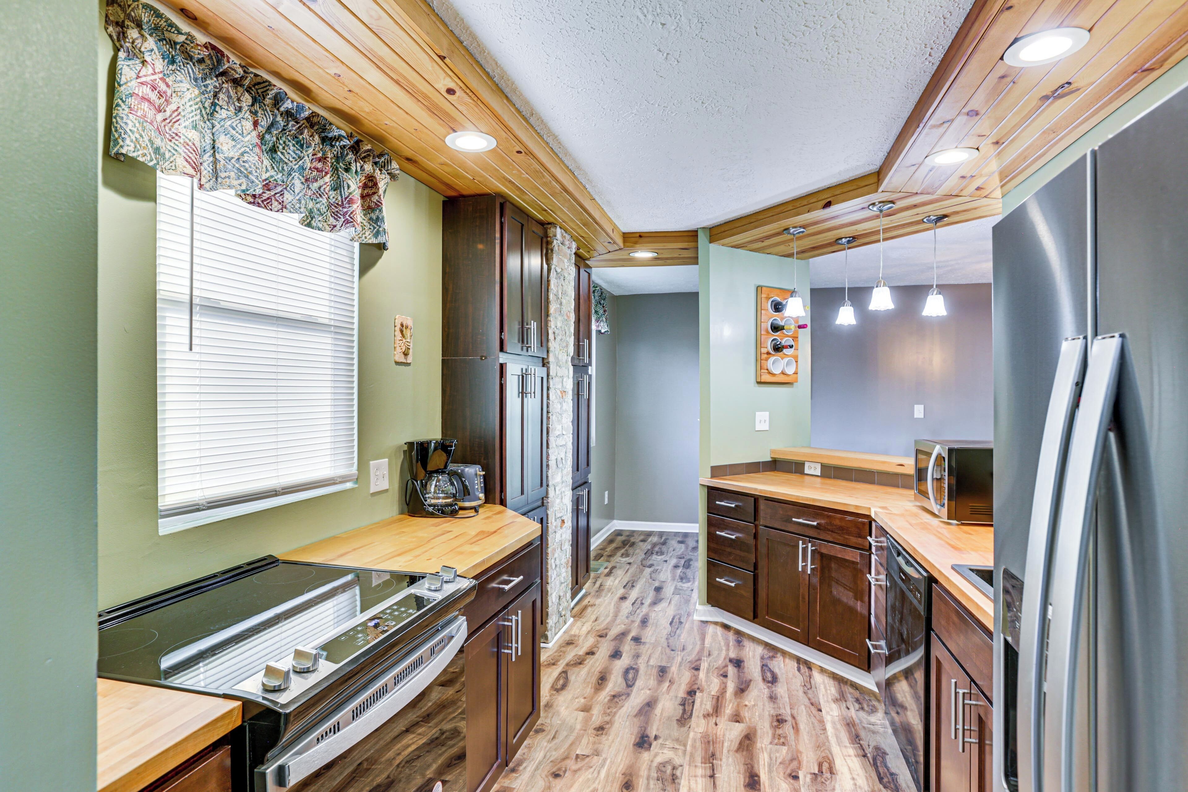 A compact kitchen with wooden cabinets, a built-in stove, and a refrigerator.