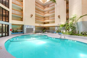 An indoor swimming pool with multiple levels of balconies, surrounded by indoor plants and a clear pool area. - Steps to Sand! Retreat w/ 2 Pools in Hilton Head (Hilton Head Island)