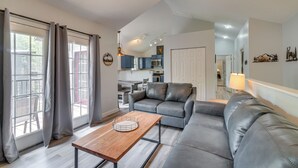 A modern living room with a sofa, a coffee table, and a ceiling fan. - Modern Gatlinburg Retreat w/ Private Hot Tub (Gatlinburg)