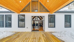 A modern building with a wooden deck and large windows. - Gateway to Adventure! Brand-new Gloversville Home (Gloversville)