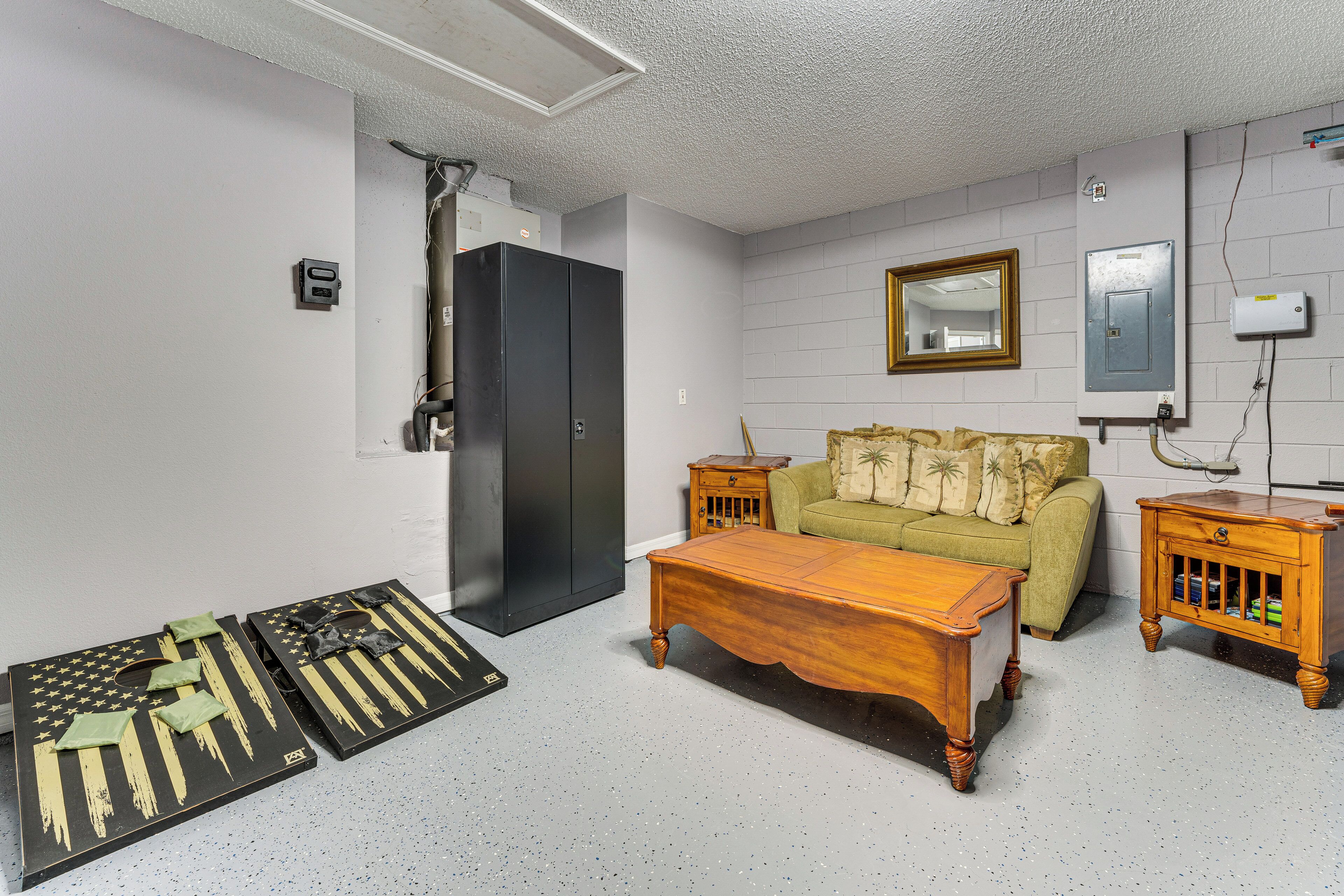 A room with a green sofa, wooden coffee table, and two nightstands.