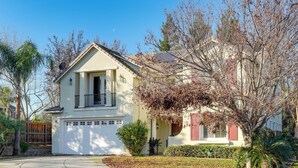 A single-story house with a garage, a front porch, and a small front yard with a tree and shrubs. - Near Wineries & Parks: Waterfront Tracy Getaway! (Tracy)