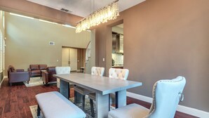 A dining area with a light-colored table and matching chairs, a chandelier, and a view into the kitchen. - Near Wineries & Parks: Waterfront Tracy Getaway! (Tracy)