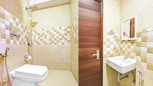 A bathroom with a toilet, shower, and sink. - Roomshala Hotel Smart  (New Delhi)