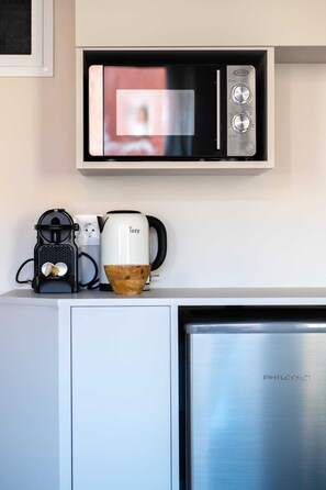 A kitchenette with a microwave, coffee maker, and kettle on a white countertop. - Hanim Boutique | Old Town lux Studio with hot tub, Studio (Chania)