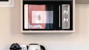 A kitchenette with a microwave, coffee maker, and kettle on a white countertop. - Hanim Boutique |Old Town lux Studio with hot tub 2, Studio (Chania)