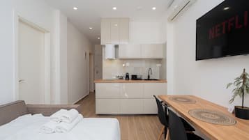 Escritorio, tabla de planchar con plancha, wifi y ropa de cama