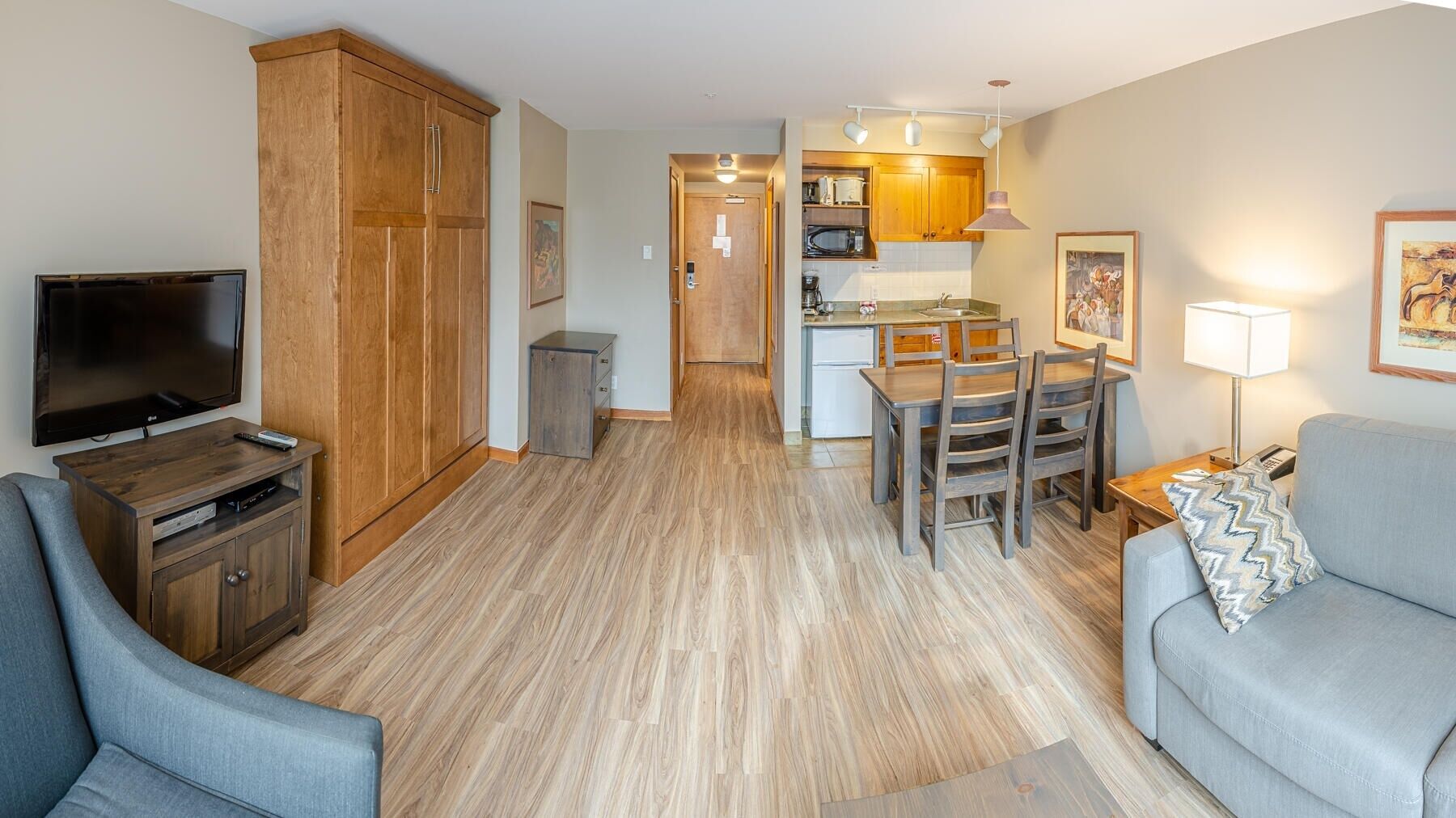A modern apartment with a living room, a dining area, and a kitchen.