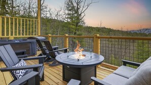 A deck with outdoor seating and a fire pit. - Three Pines 2 Bedroom Home (Sevierville)