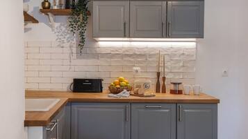 Classic Townhome, Garden View | Private kitchen | Mini-fridge, microwave, stovetop, dishwasher