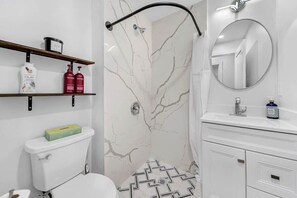 Shower, hair dryer, towels, shampoo