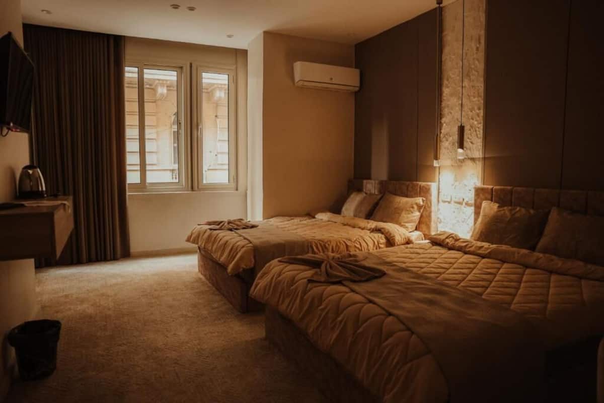 Deluxe Quadruple Room, City View | Desk, laptop workspace, blackout drapes, soundproofing