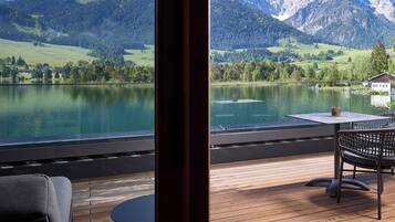 A terrace with a view of a lake and mountains.