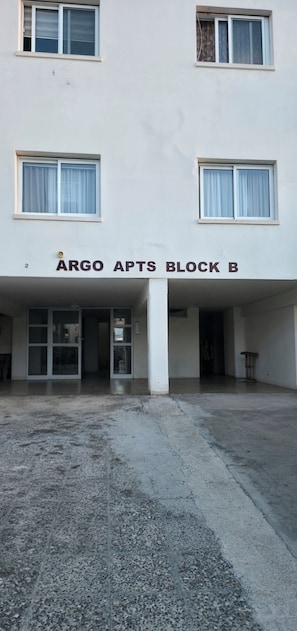 A building with a sign reading 'ARGO APTS BLOCK B' above the entrance. - Cozy 2-Bed Apartment by the Kings Avenue Mall (Pafos)