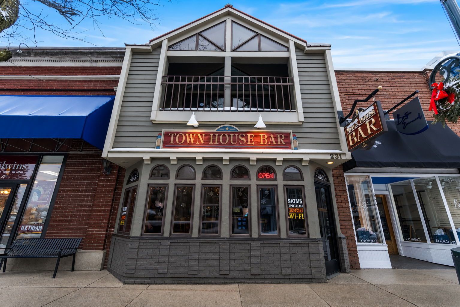 A two-story building with a sign reading 'Town House Bar' and 'Row House Bar' on the upper level.