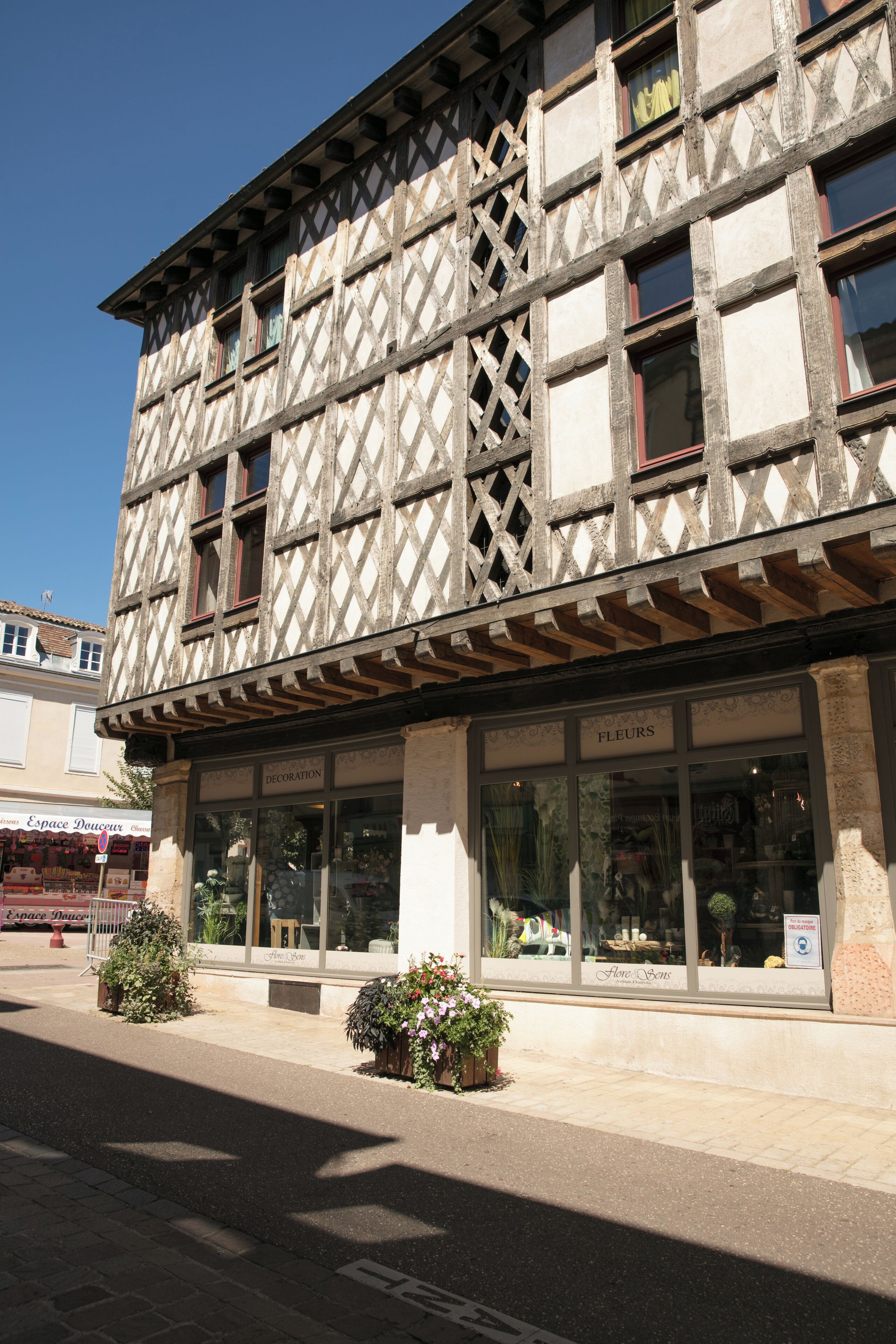 A traditional half-timbered building with a shop on the ground floor.