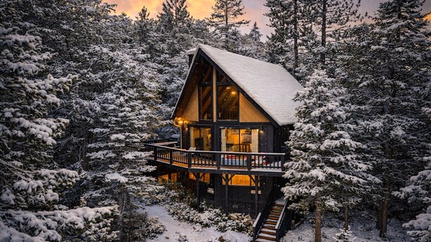 A cabin with a balcony, surrounded by snow-covered trees. - Walk to Bear Mountain Slopes! Hot Tub Game Room! Fire Pit! Super cute! (Big Bear Lake)