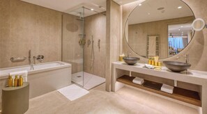 A modern bathroom with a glass-enclosed shower, a large mirror, and a vanity with two bowls. - Stylish Studio • Terrace & Open Views (Rabat)