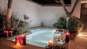 A spa area with a hot tub, surrounded by candles and plants. - The 1813 Painter s House by Neuvel (Delphi)