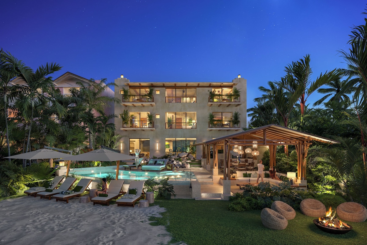 A multi-story resort with a swimming pool, lounge chairs, and a covered outdoor area.