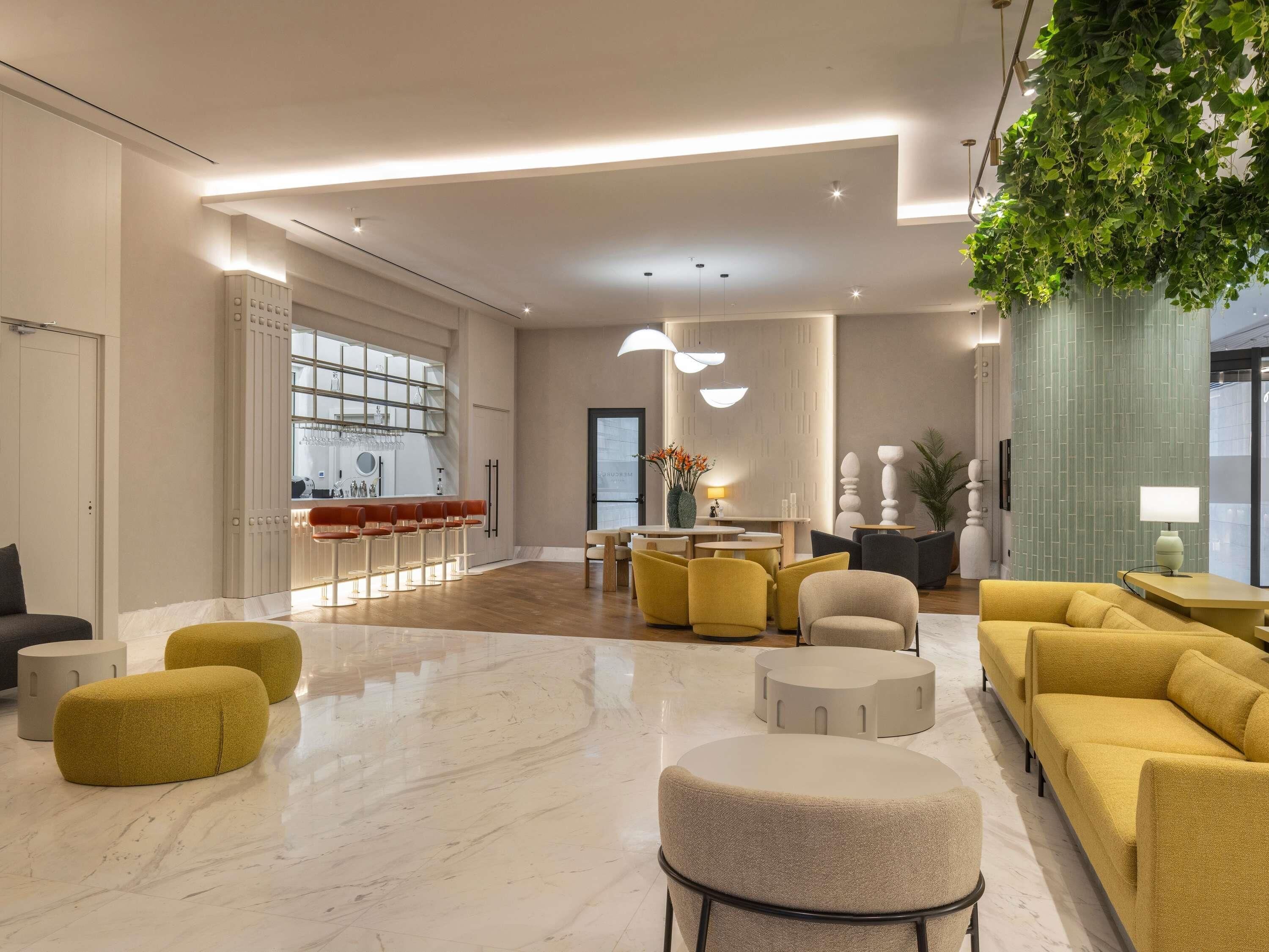 A spacious living area with a bar, seating, and a large window.