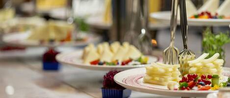 A buffet setup with various food items and utensils.