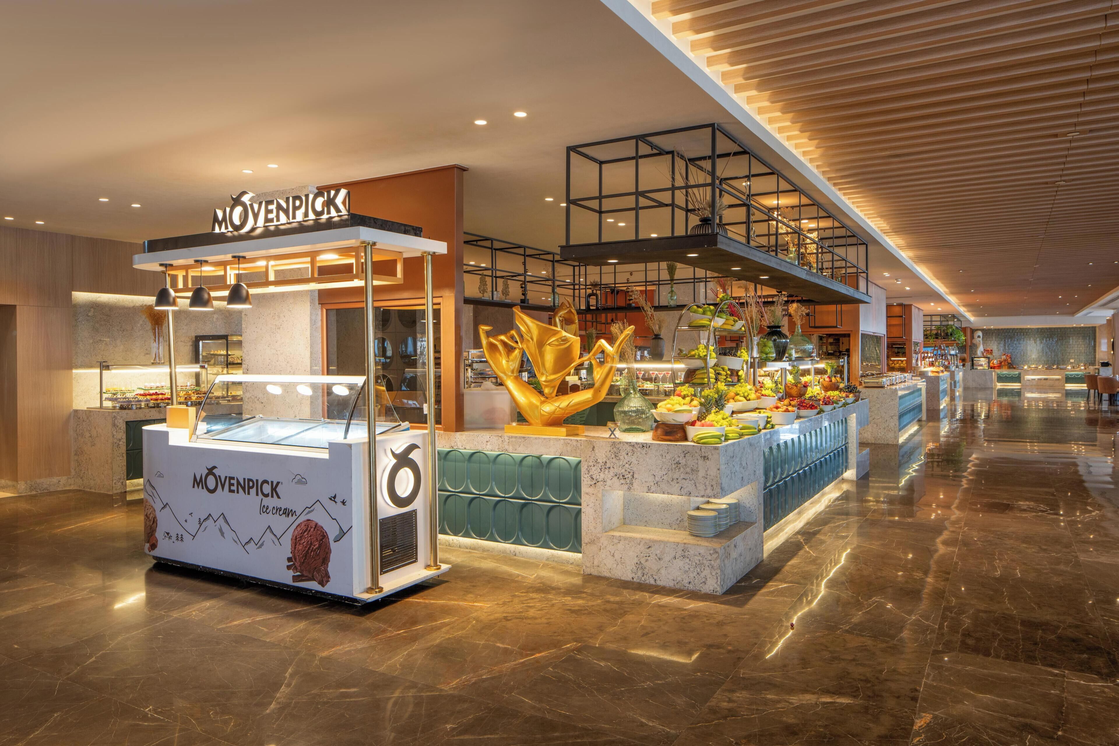 A food kiosk with a sign reading 'MOVENPICK' and a display of ice cream.
