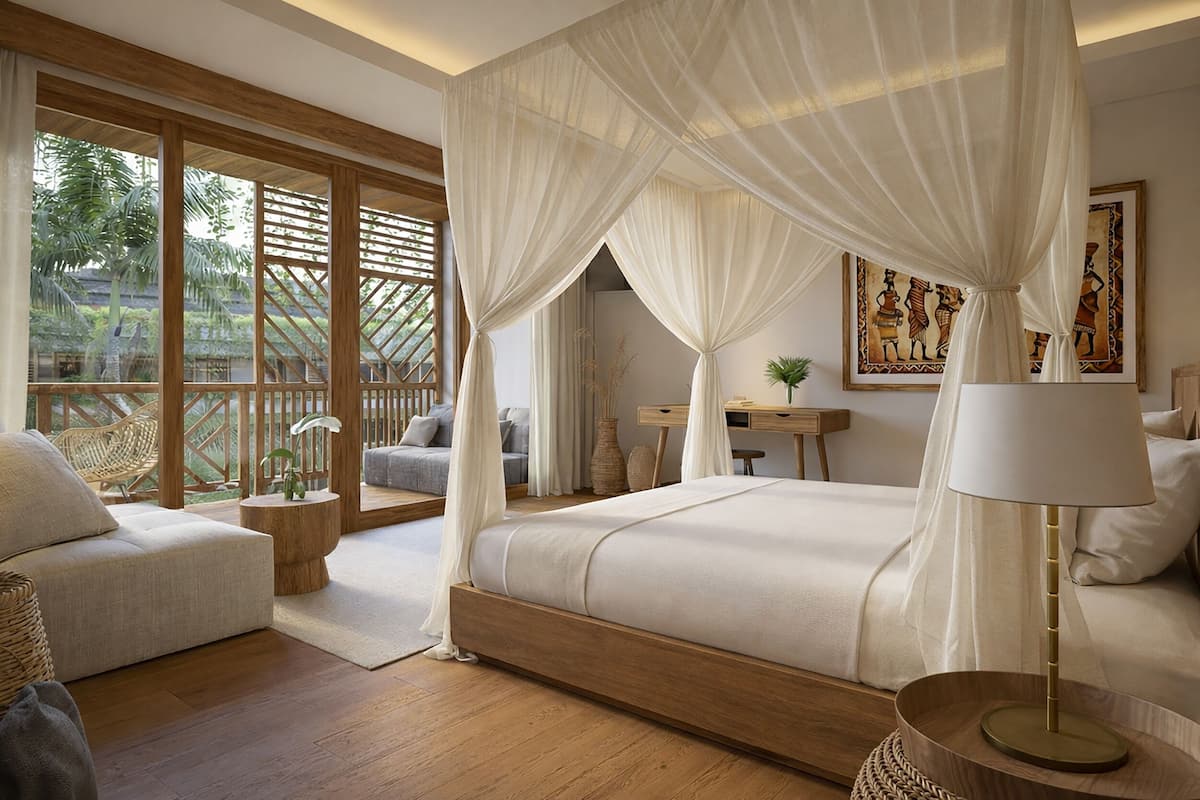 A bedroom with a canopy bed, a desk, a chair, and a view of the outdoors.