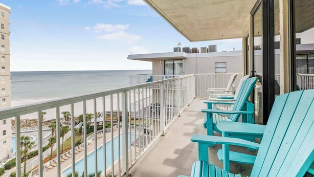 A balcony with turquoise chairs overlooking a pool and the ocean. - 🌴Gulf Views + Resort Amenities | Walk 2 Beach | Seaside Beach & Racquet 5914 (Orange Beach)