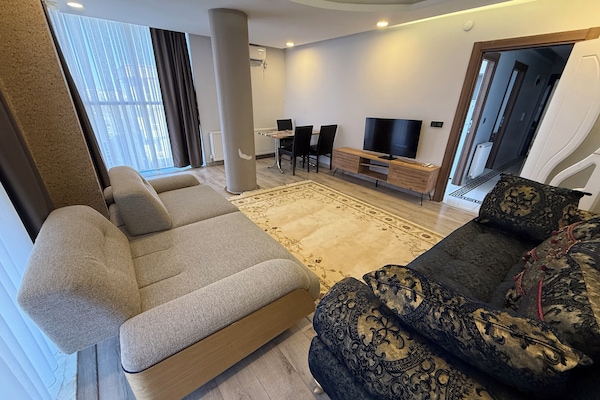 Deluxe Apartment, City View | Living area | TV