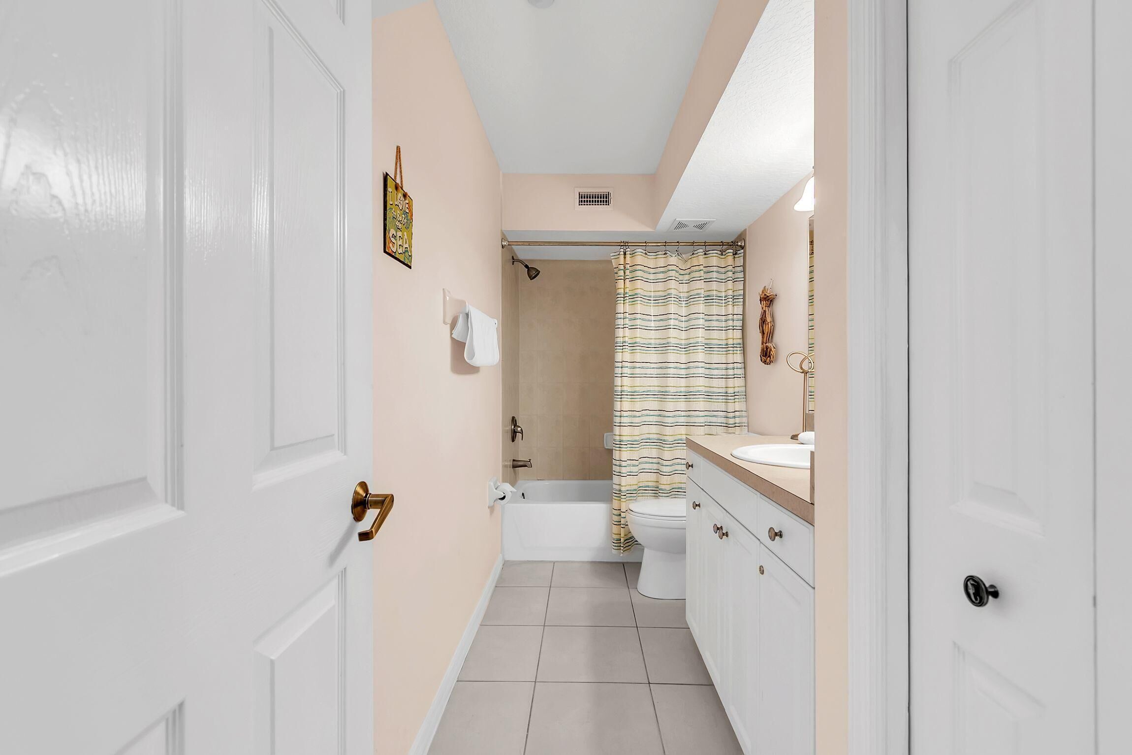 A bathroom with a bathtub, toilet, and sink.