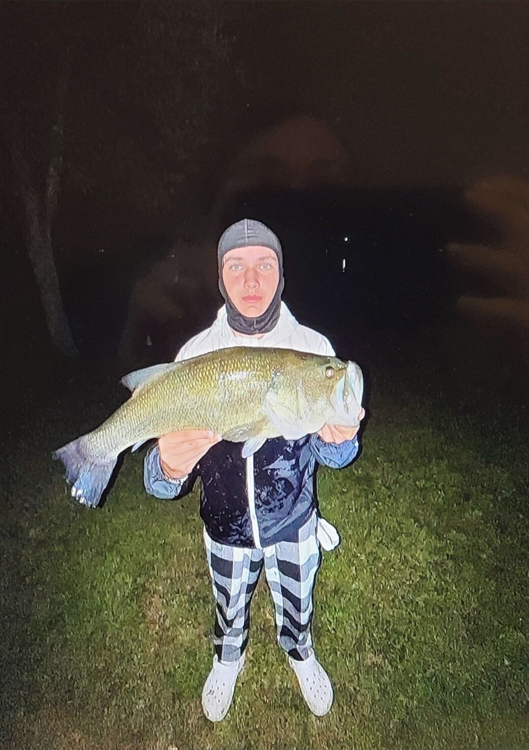 A person holding a large fish.