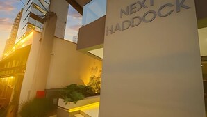 A modern building with a sign reading 'NEXT HADDOCK' and a staircase leading to an entrance. - Next Haddock 92 (São Paulo)