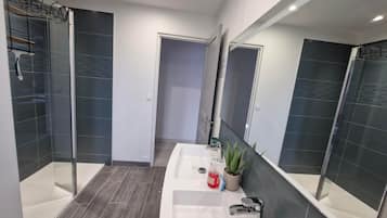 Shower, hair dryer, towels, toilet paper