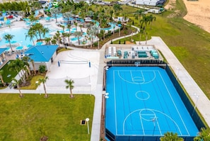 A resort with a swimming pool, a basketball court, and a beach area. - 5BR Family Pool Home Near Disney (Davenport)