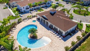 A residential complex with a swimming pool, multiple buildings, and a well-maintained lawn. - Home in West Lucaya | 4BR Near Disney (Kissimmee)