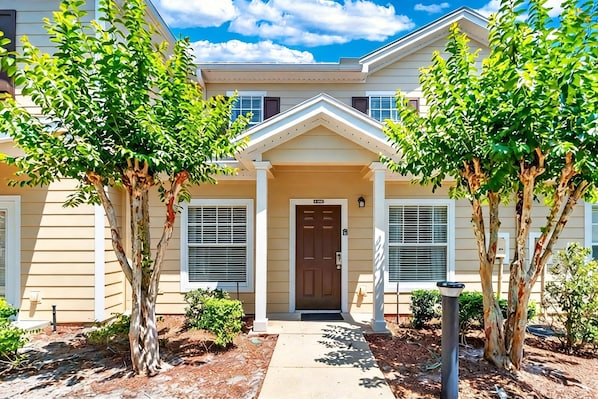 A two-story building with a central entrance, a front porch, and a mailbox. - 3BR Home Near Disney at Lucaya Village (Kissimmee)