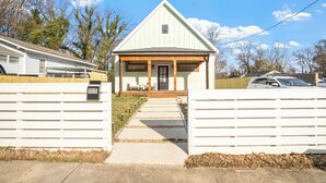 A single-story house with a front porch, a garage, and a driveway.