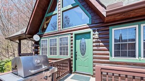 A log cabin with a green door, a deck, and a Char-Broil grill. - Mountain Laurel-Secluded Beauty + Majestic Views! (Maggie Valley)