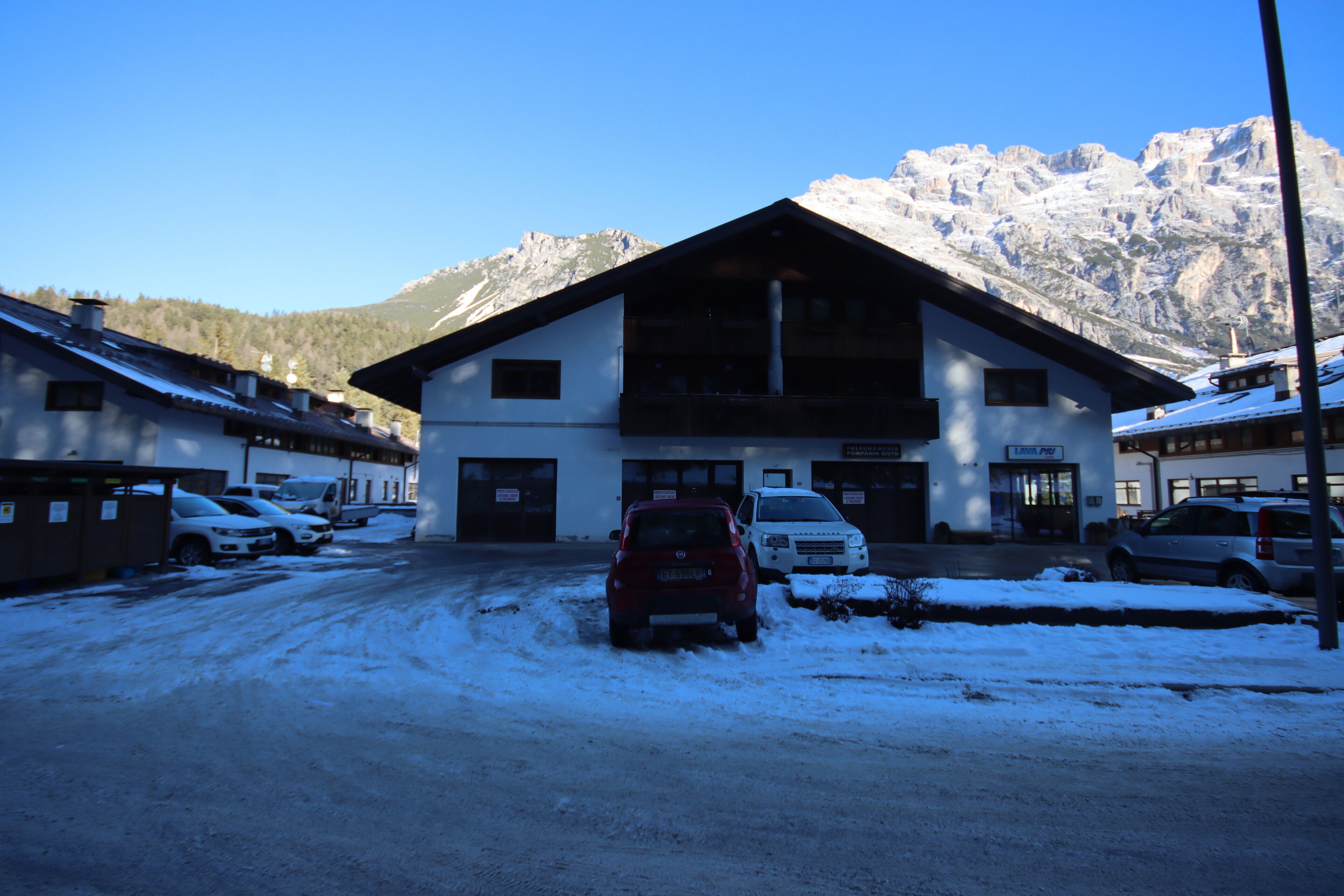 A building with a large entrance and a mountain backdrop.