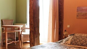 A room with a bed, a chair, a table, and a window. - Apartment 2 - Morning awakening - light-flooded maisonette in the count's forester's lodge (Temmen-Ringenwalde)